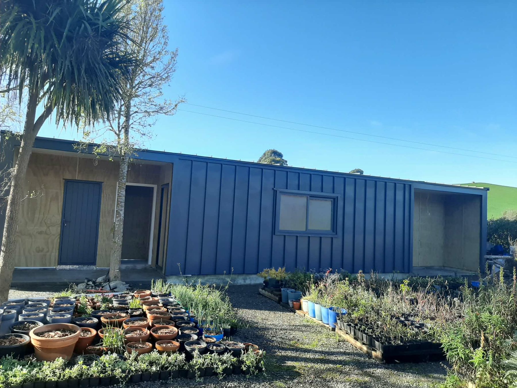 TopNotch Roofing blue standing seam wall cladding project